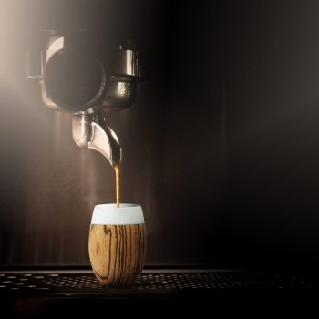 Hot coffee flow to a cup on espresso machine